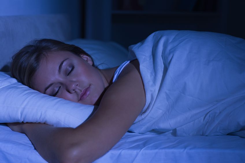 Serene woman sleeping at night in the bedroom on perfect mattress 